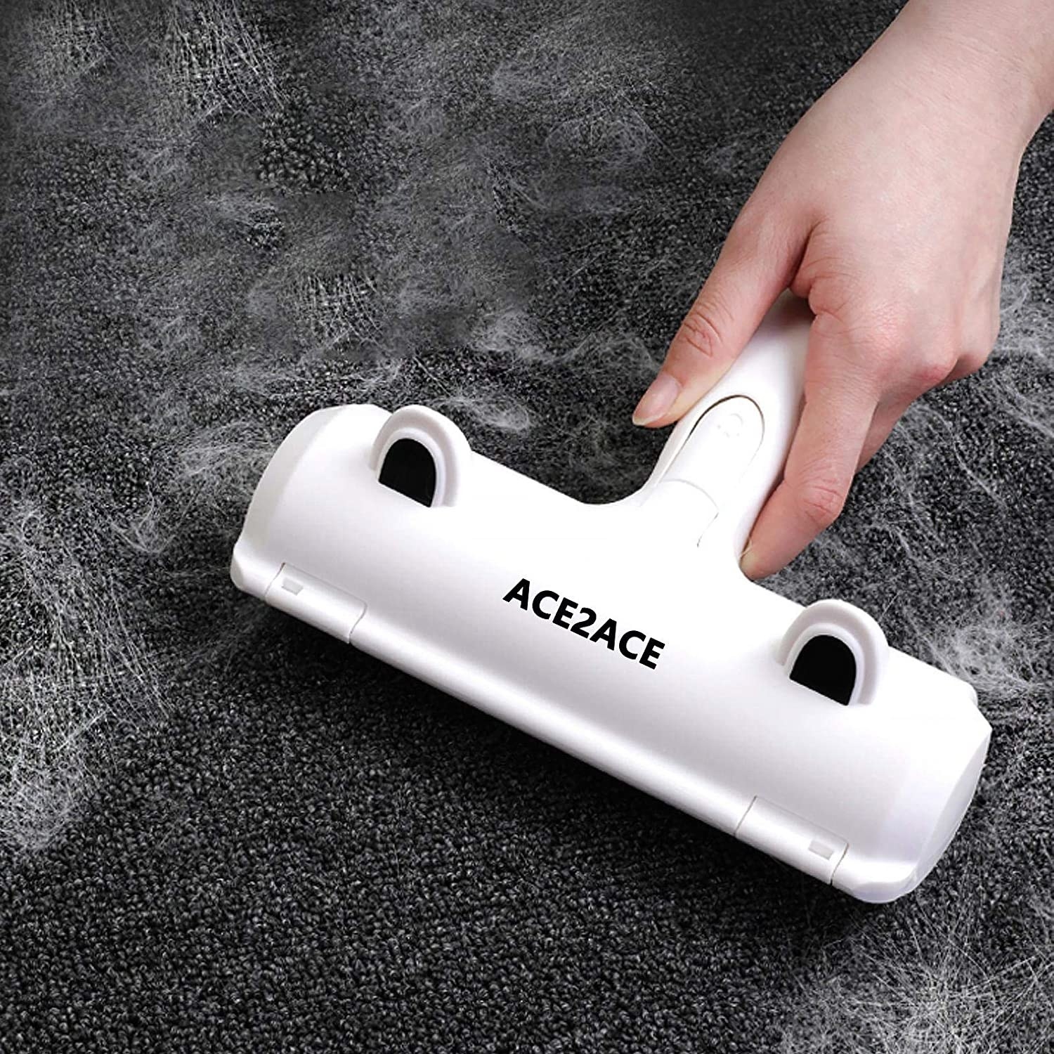 The lint roller collecting fur off of a fabric surface