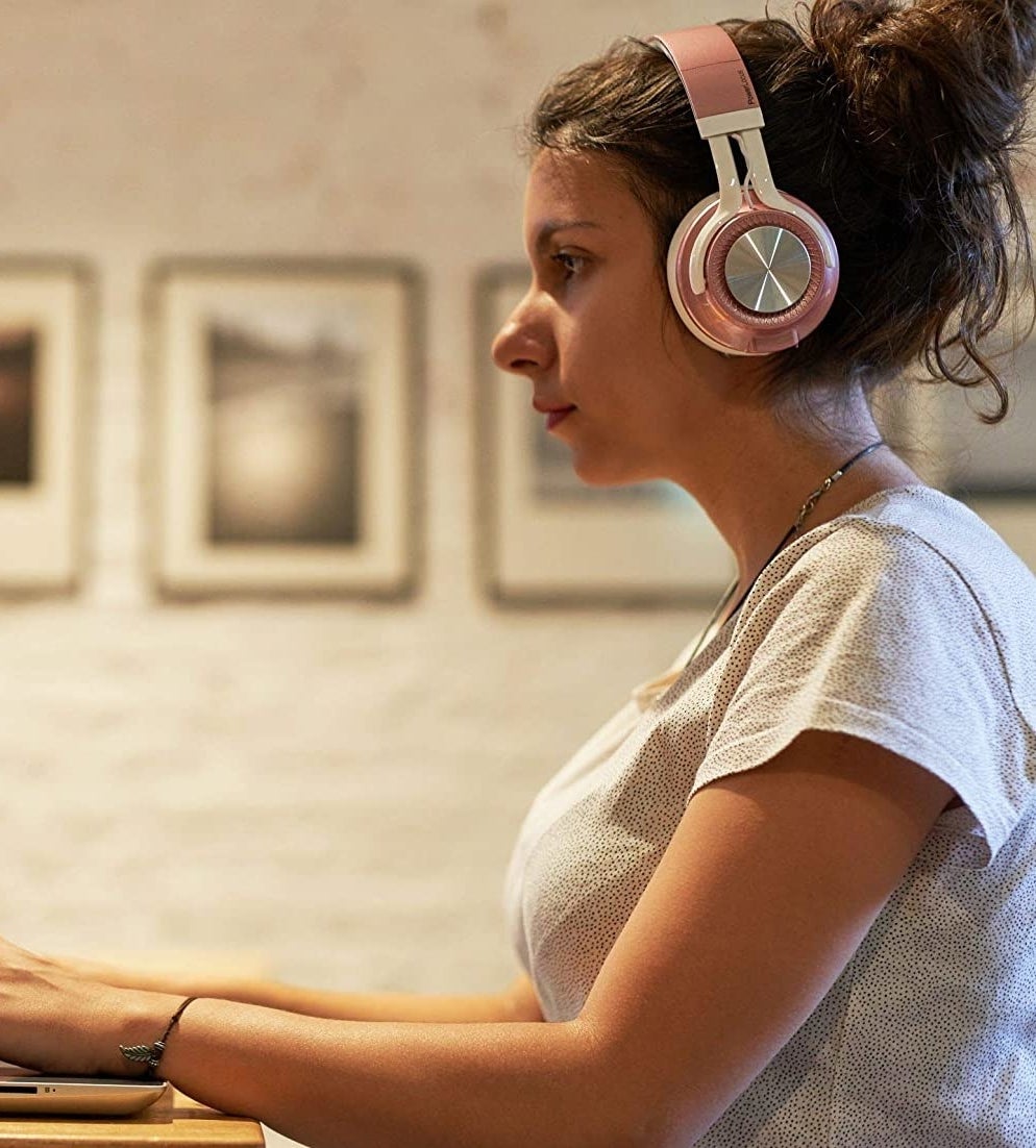 person with headset typing on a computer