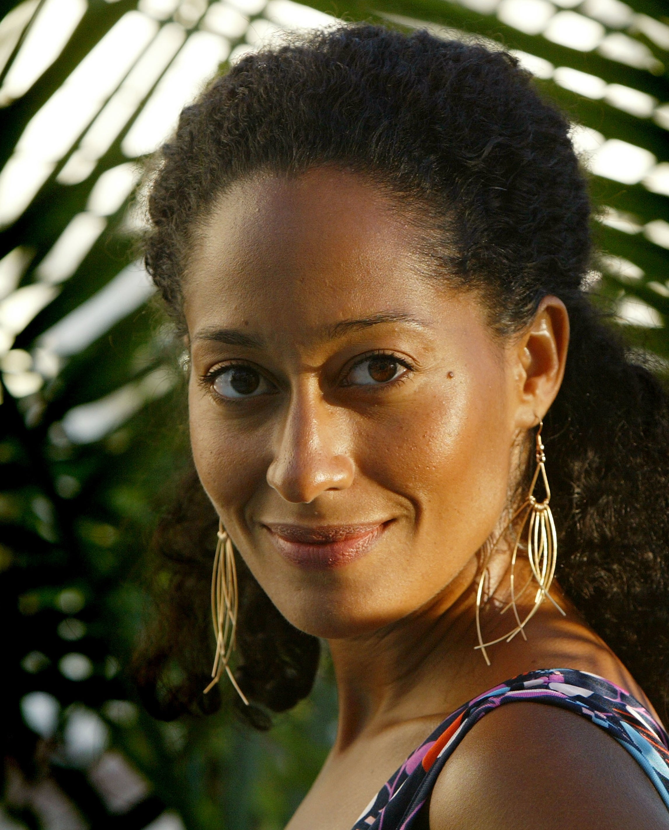 Tracee Ellis Ross with her natural hair half-up, half-down, smiling