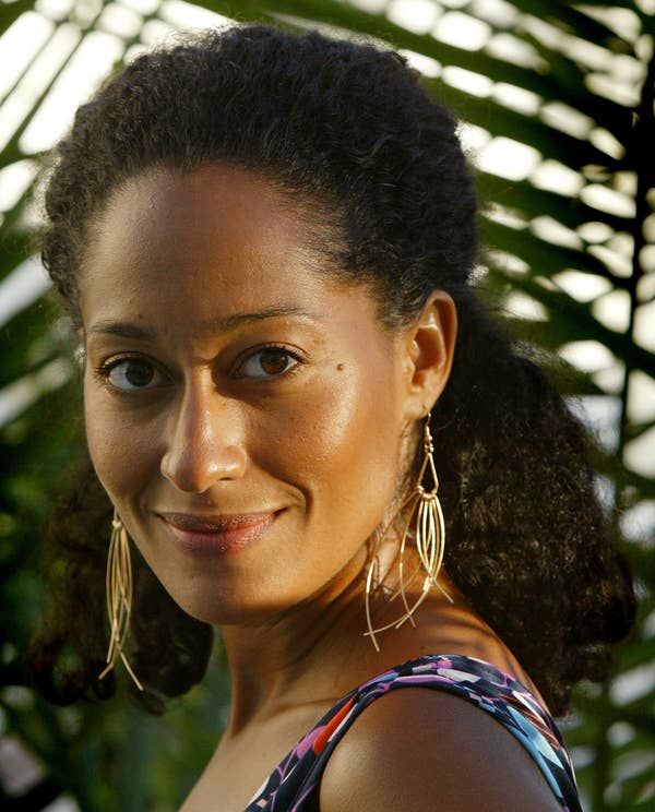 Tracee Ellis Ross with her natural hair half-up, half-down, smiling