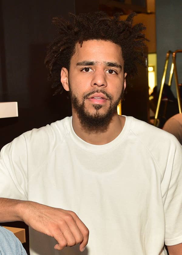 J-Cole in a white t-shirt looking at the camera