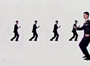 david byrne dance walking around the screen in the music video for once in a lifetime 
