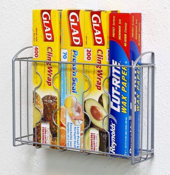 Shelf mounted to wall with boxes of cling wrap and aluminum foil inside