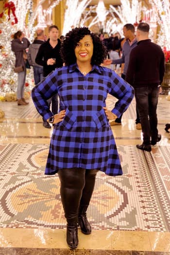 A customer review photo of them wearing the blue and black buffalo plaid long-sleeve dress