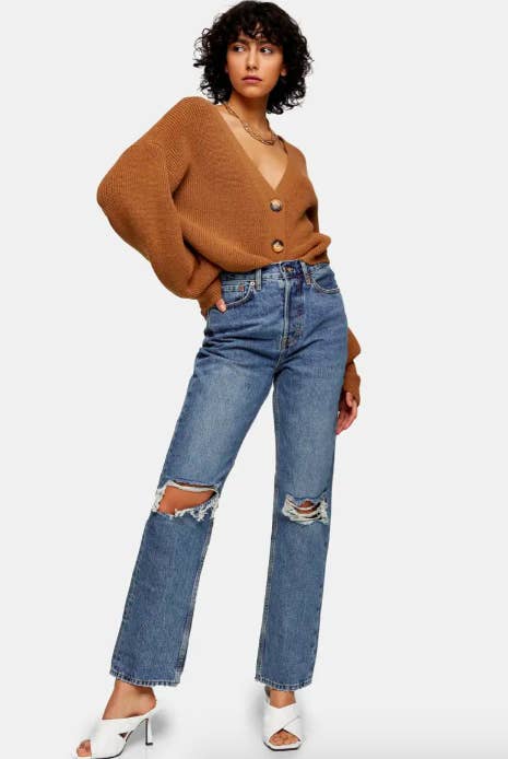 A model wearing the dad jeans with heels and a sweater