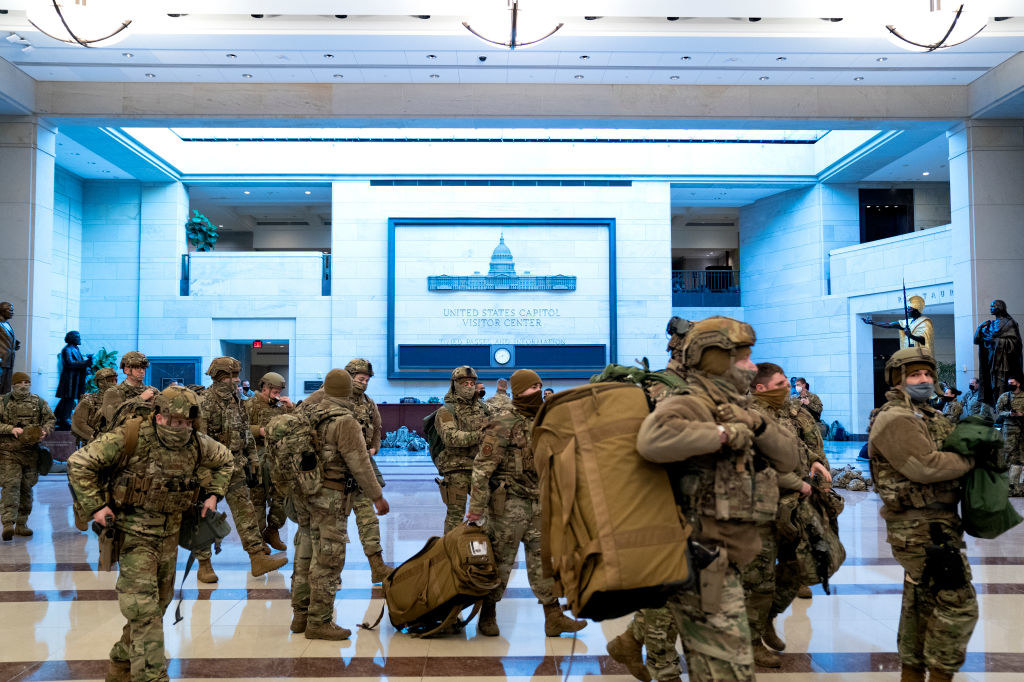 National Guard members in full gear walking through the US Capitol Visitor Center