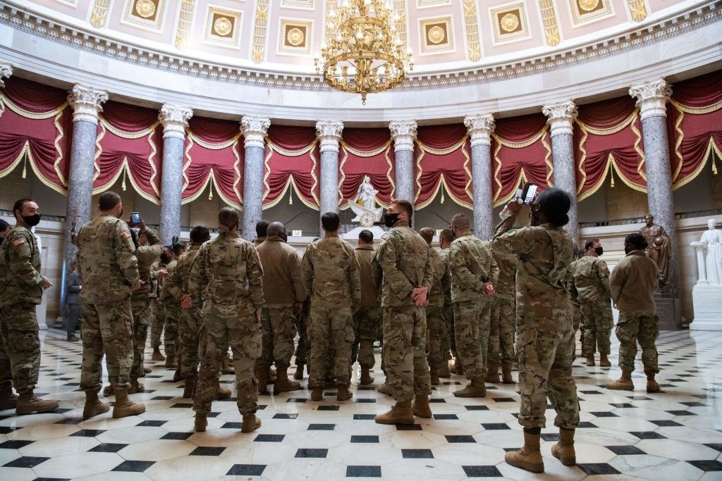 National Guard members standing in a rotunda inside the Capitol