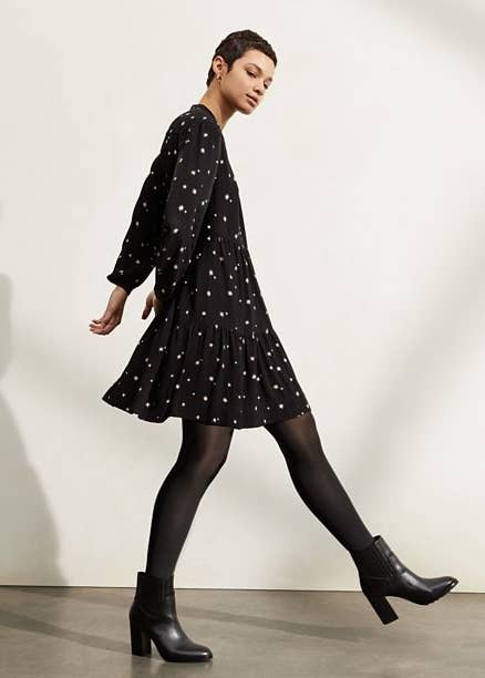 Model in black star print dress