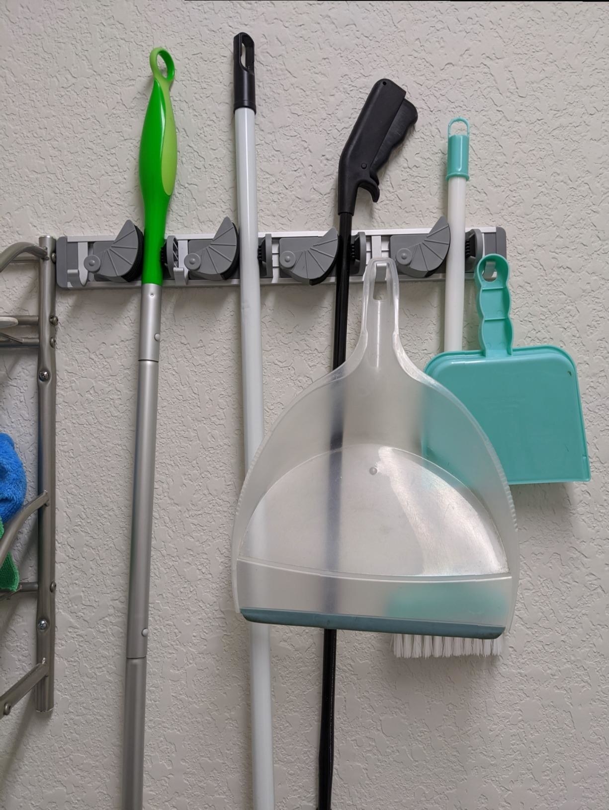 Reviewer photo of various cleaning tools placed in storage holder