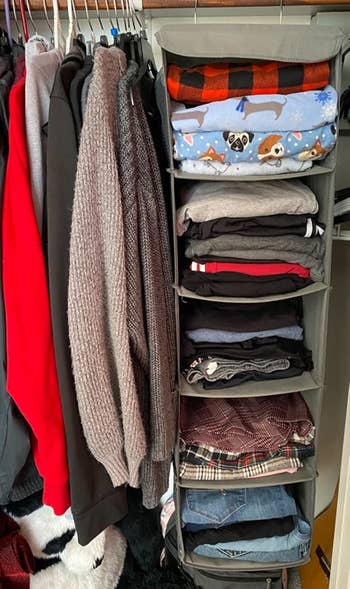 Gray hanging organizer with folded jeans and pajama pants