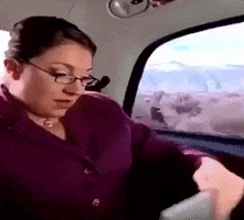 GIF of the Super Nanny in the back of a car saying &quot;You guys are in crisis, I am on my way&quot; 