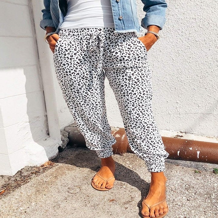 A model wearing the black and white leopard drawstring pants
