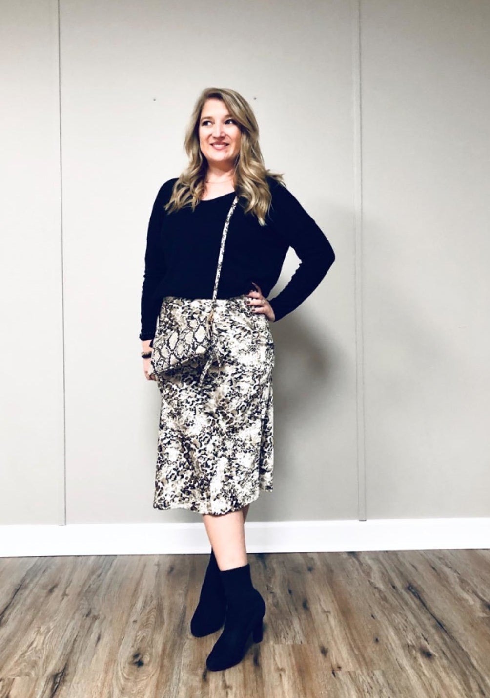 reviewer wearing the slip skirt in white and black snakeskin print
