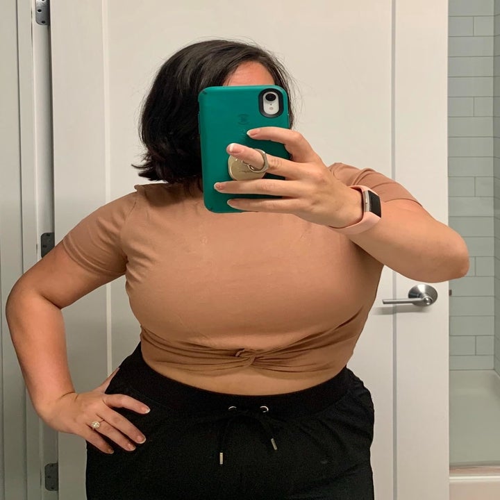 A reviewer wearing the top in khaki