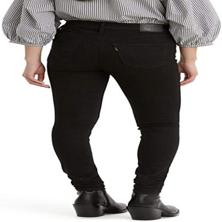 Back view of a model wearing the black jeans