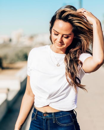 A reviewer wearing the top in white