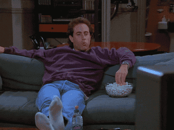 Seinfeld eats popcorn and does a fist pump