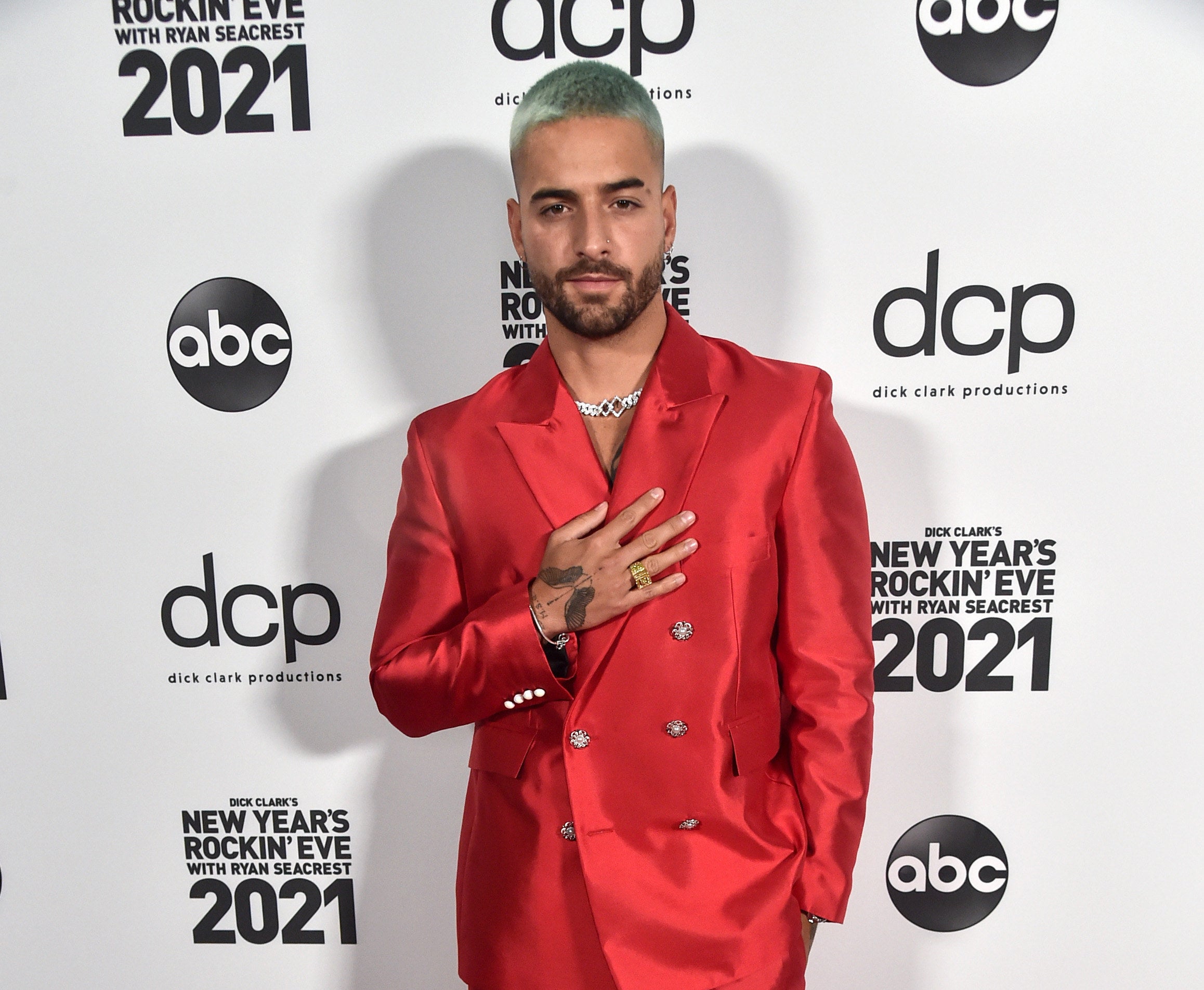 Maluma on a red carpet in a double-breasted red suit 