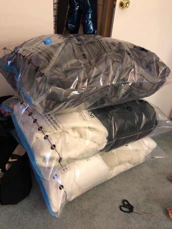 Reviewer's comforters and pillows in pre-flattened jumbo space saver bags