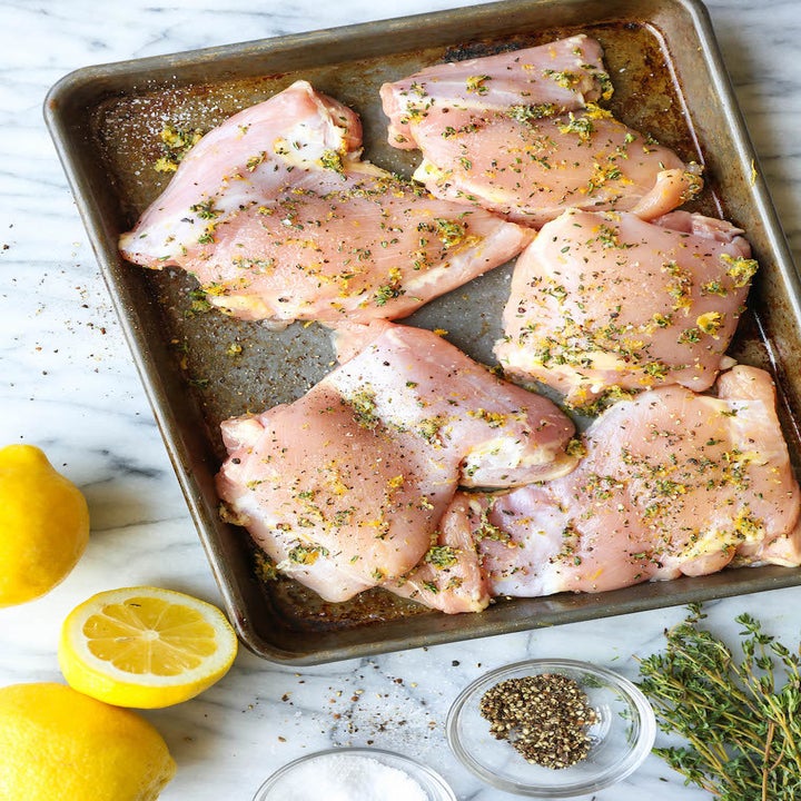 Raw chicken thighs on a tray