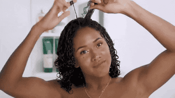 YouTuber Shameless Maya styles her wet curls using finger twists