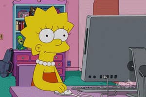 Lisa Simpson sitting at the computer with a blank expression on her face