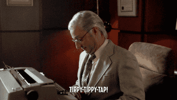 Man pretends to type on a typewriter