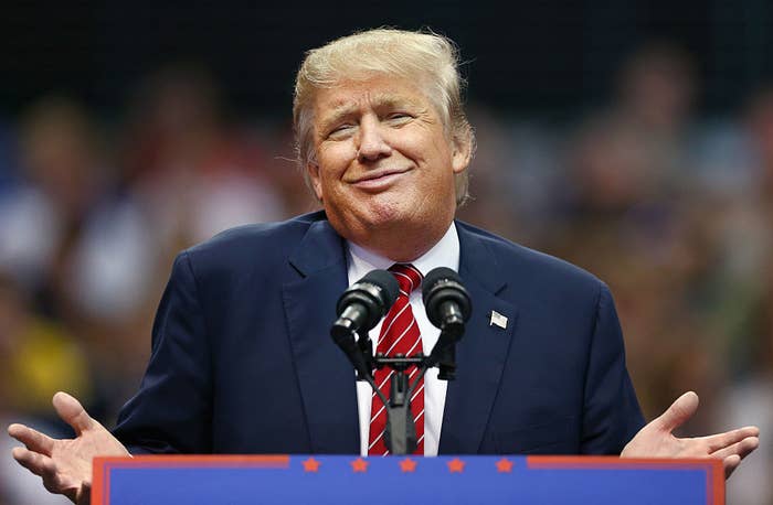 Donald Trump shrugging his shoulders at a speaking event