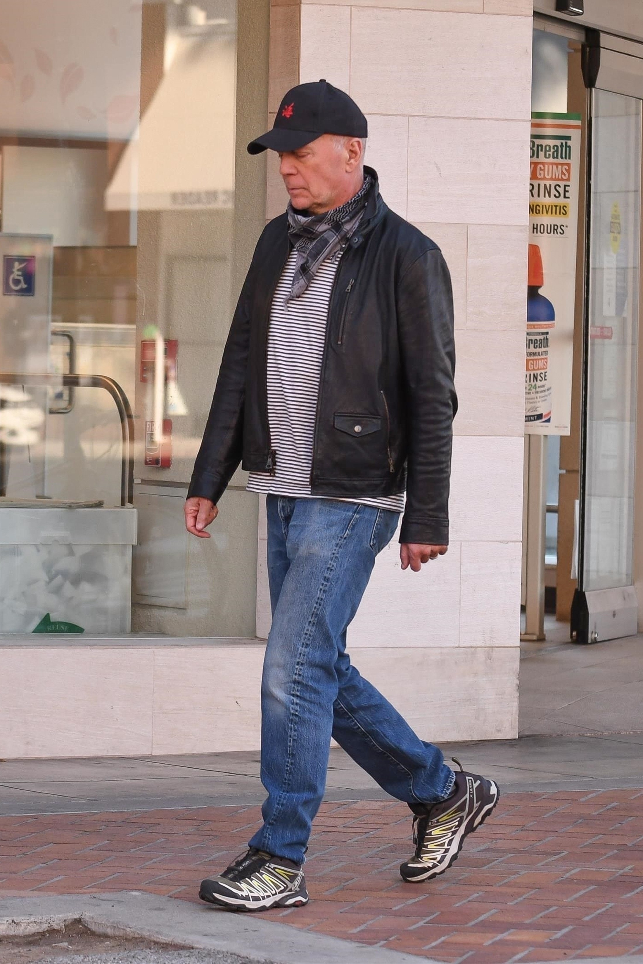 Bruce Willis is spotted walking away from a store without wearing a mask