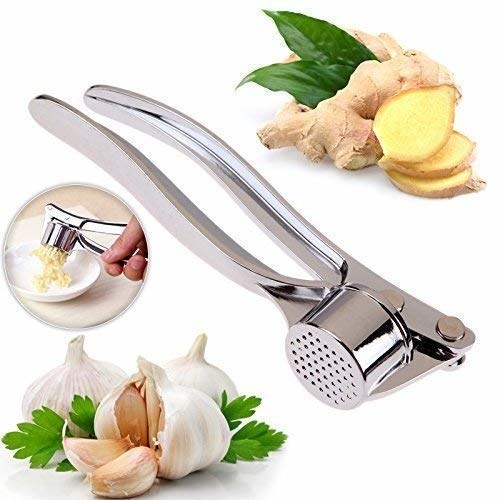 A ginger and garlic press with ginger and garlic on the side