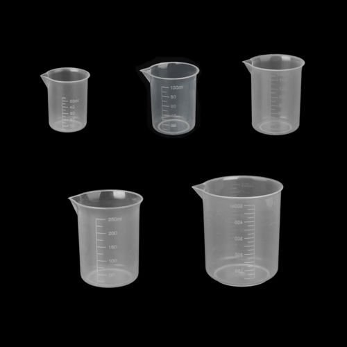 Beakers with measurement against a black background