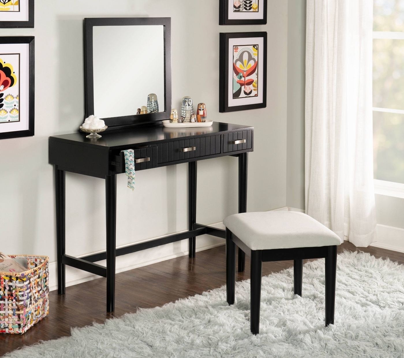 A black vanity with a square mirror and stool