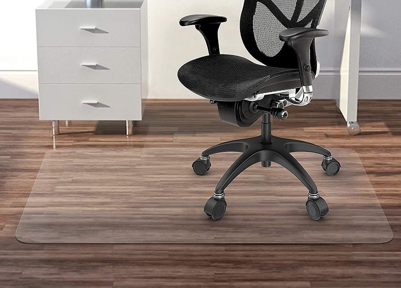 The clear mat in a home office with a rolling office chair on top