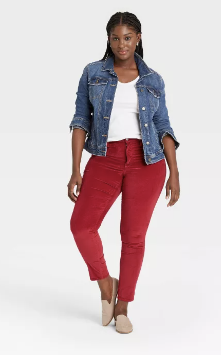 Model wears red velvet skinny jeans with a white tee and denim jacket