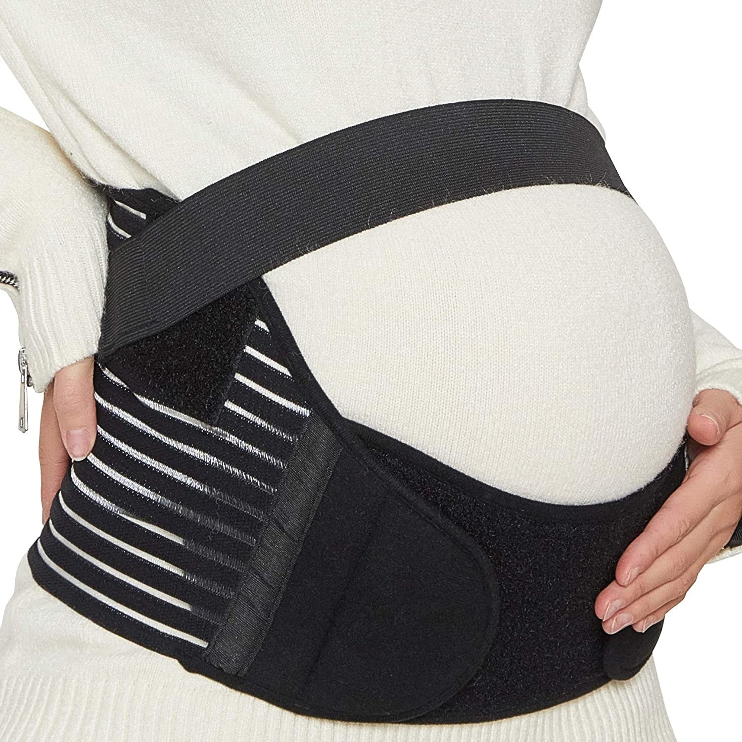 A person wearing the pregnancy belt over a sweater