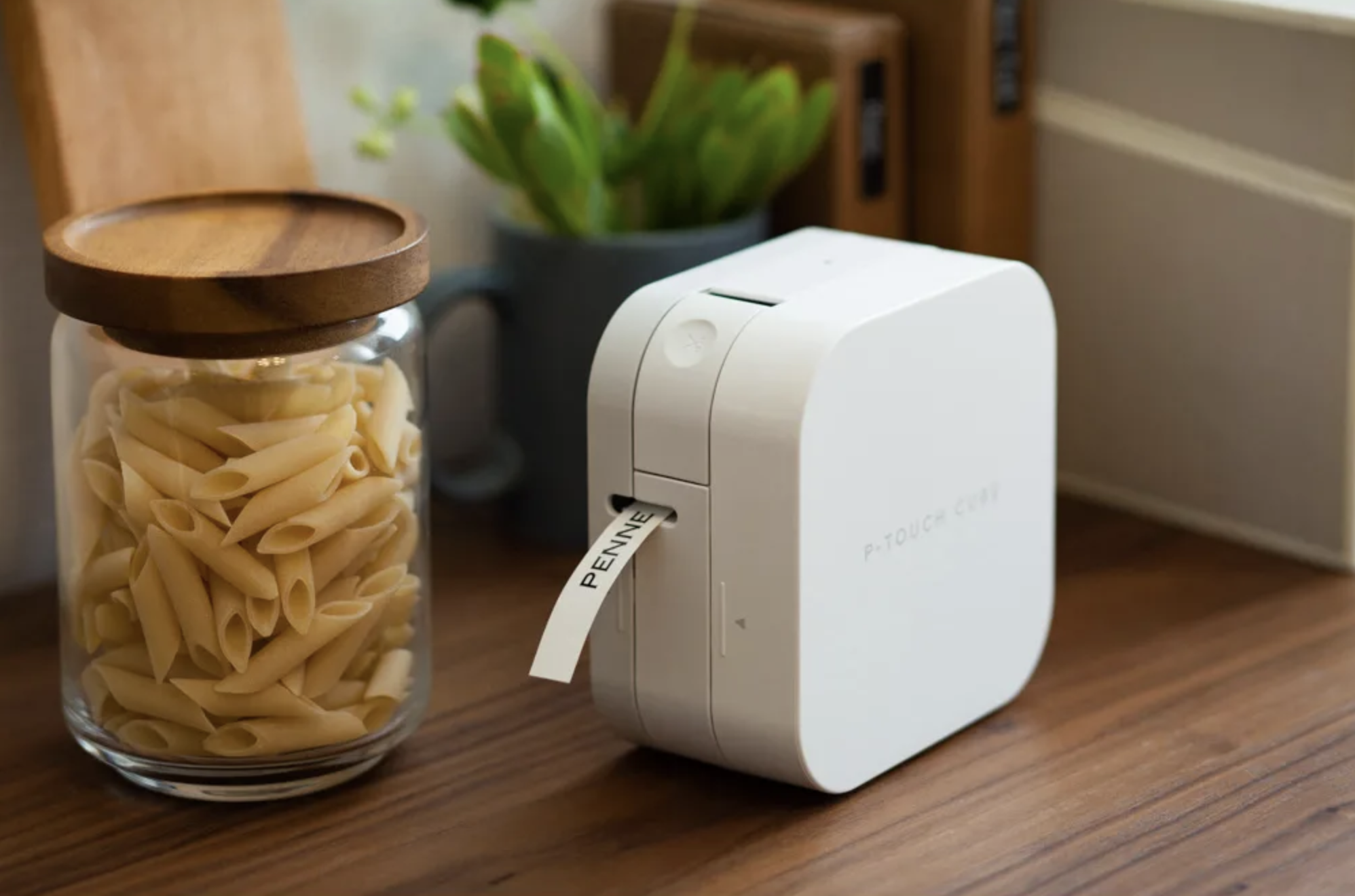 the Brother® P-touch® CUBE Smartphone Label Maker printing a penne pasta label