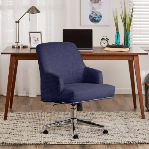 The navy office chair with studs around the rim of the chair in a home office
