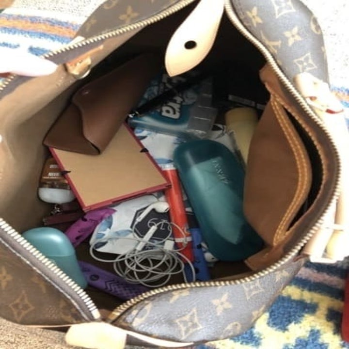 The inside of a purse looking messy and unorganized