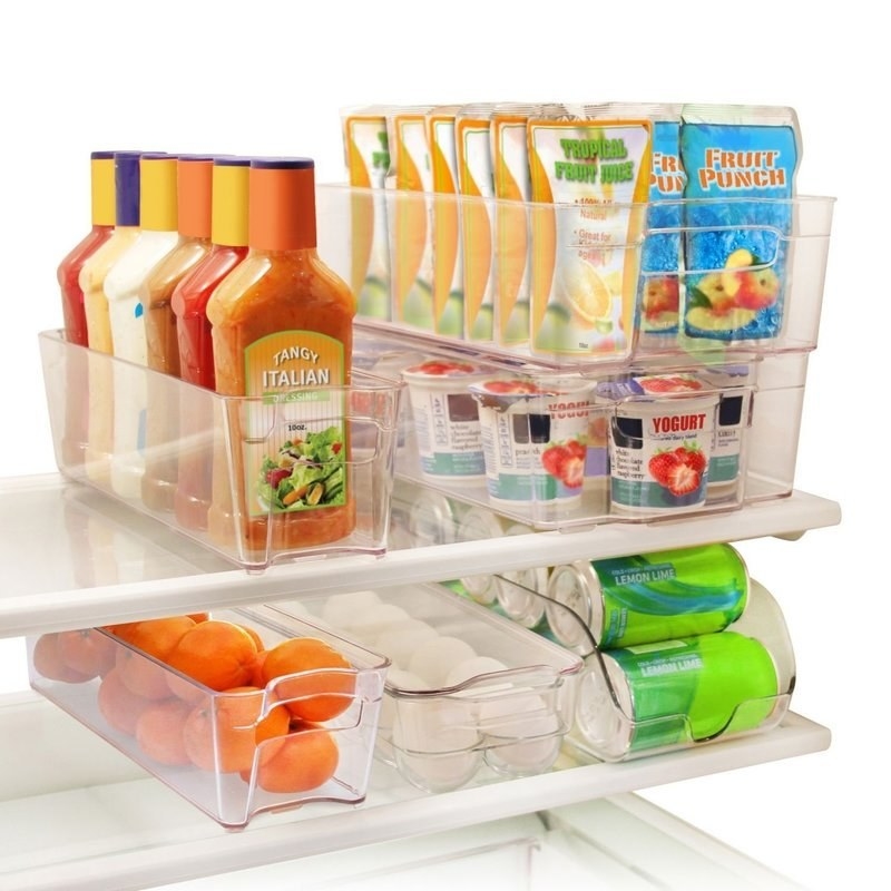 6 clear refrigerator storage bins filled with food like drinks, eggs, product, condiments, dairy