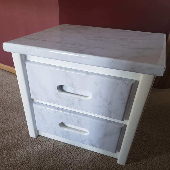 the same dresser looking brand new with the surface cover and white paint