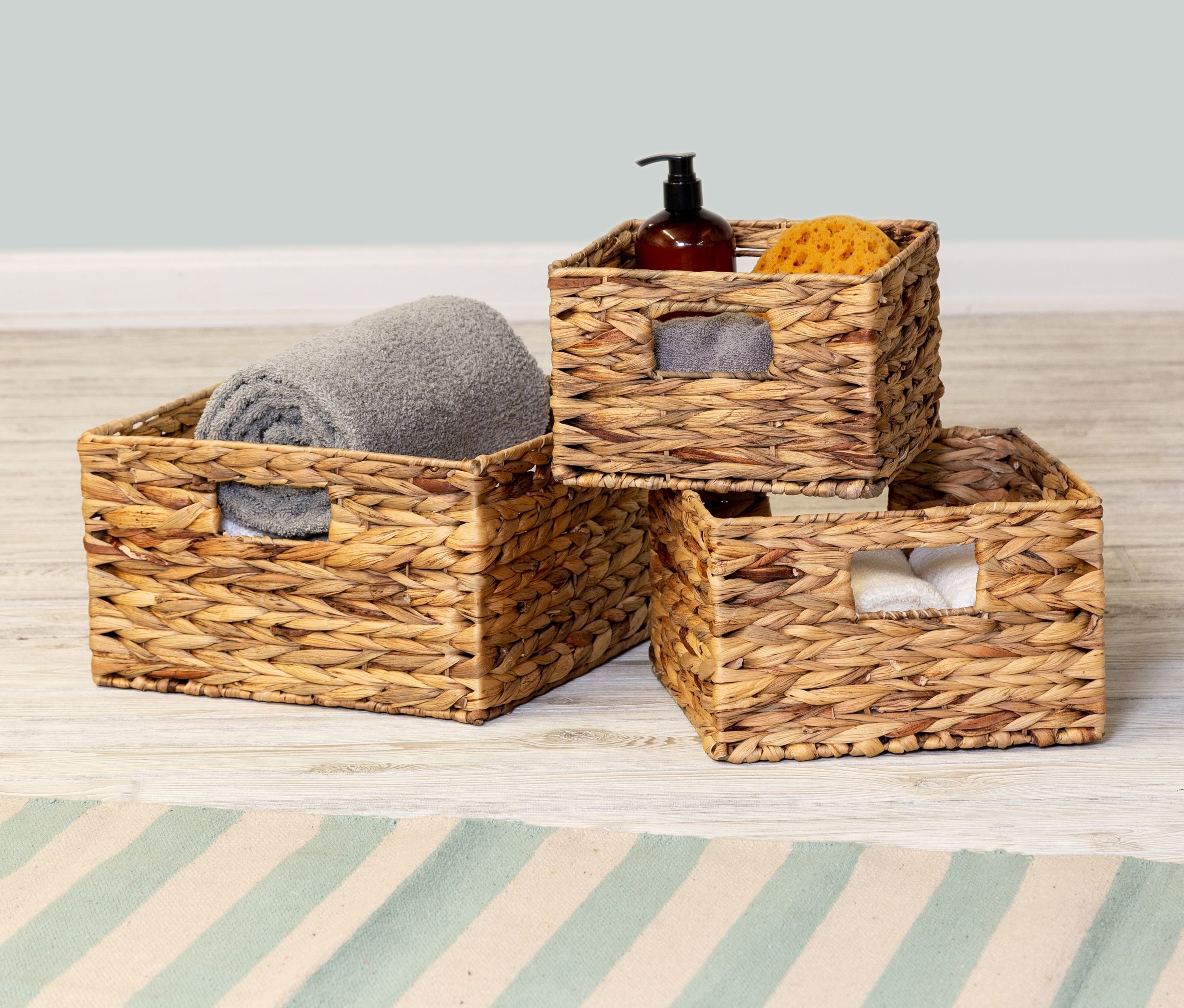 Three woven baskets with miscellaneous bath products inside