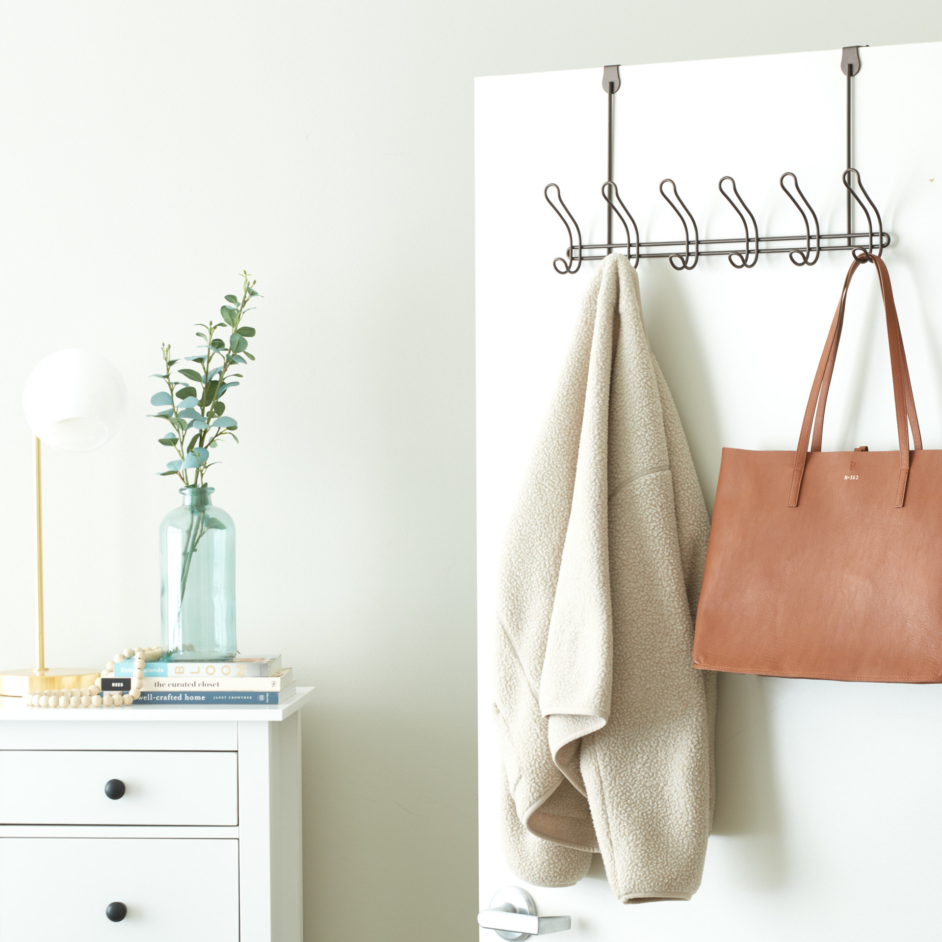 over-the-door coat rack holding a coat and purse 