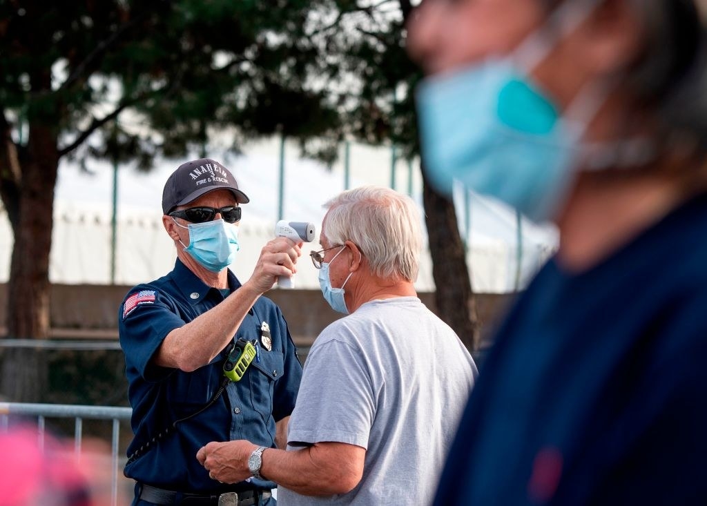 an Anaheim fire and rescue officer gives a temperature check