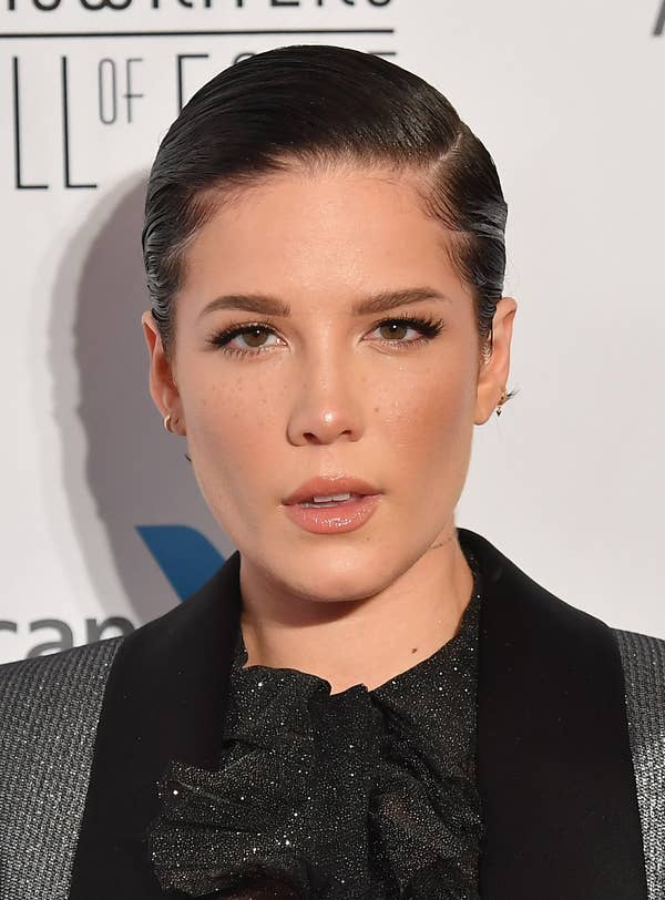 Halsey with a slicked-back pixie cut, looking directly into the camera