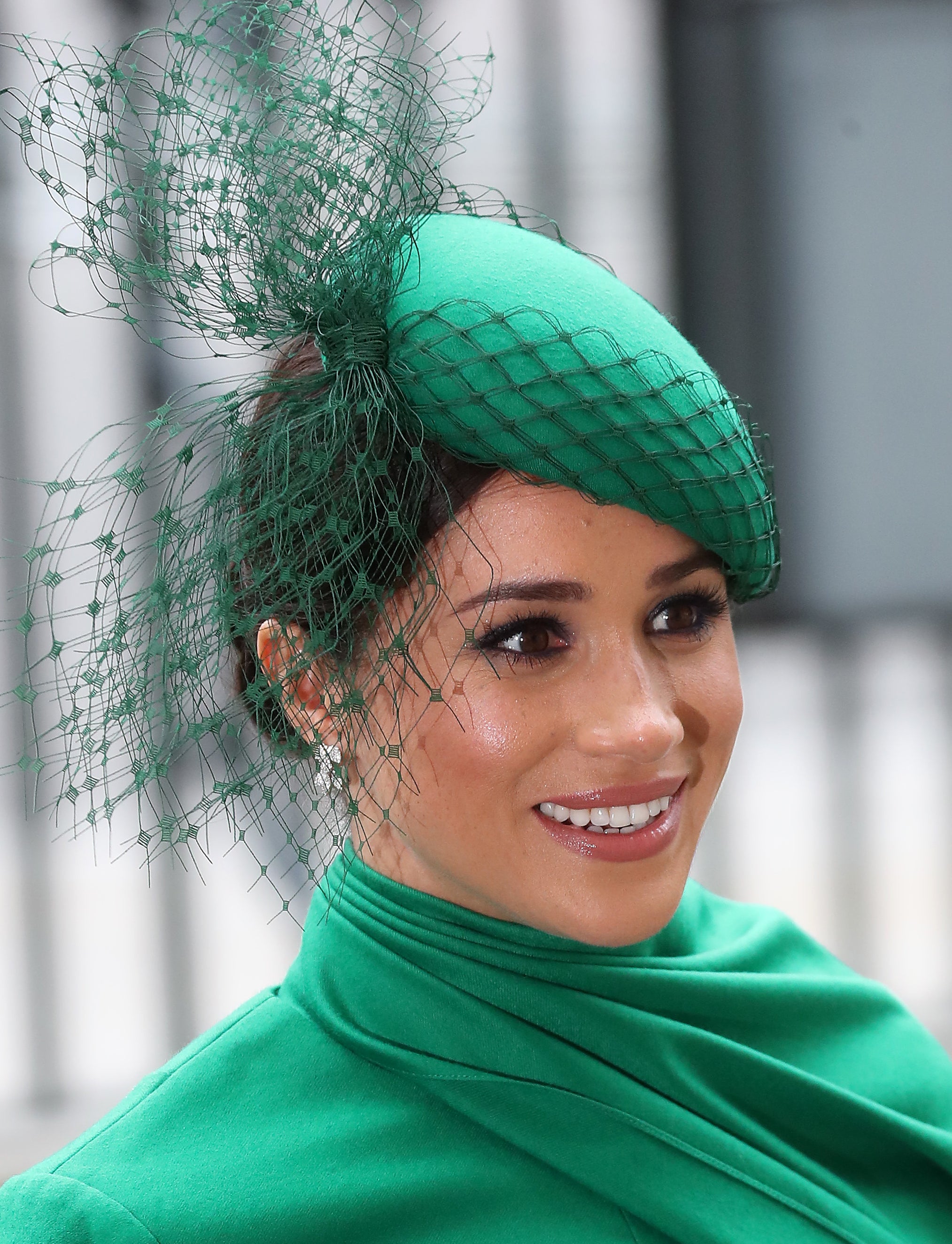 Meghan Markle wearing a green Emilia Wickstead dress with a matching green William Chambers hat