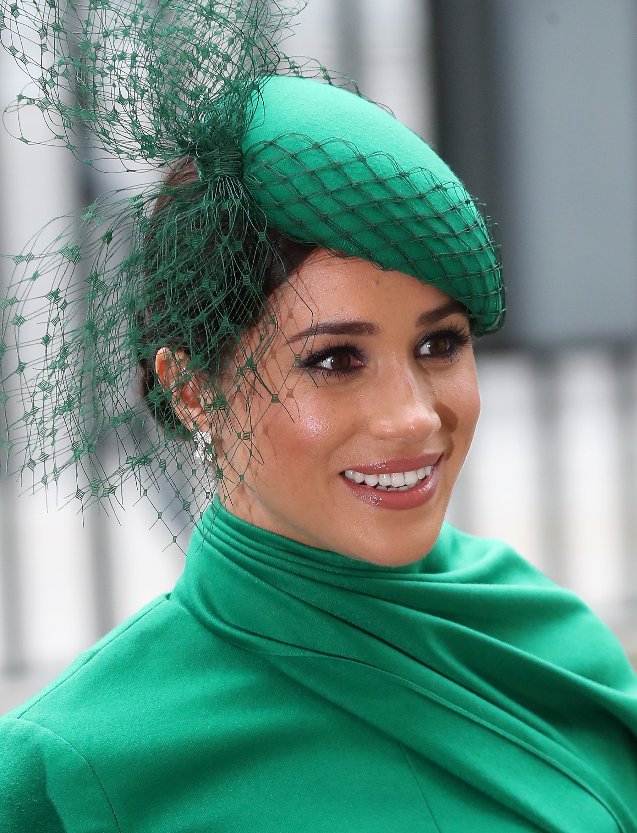 Meghan Markle wearing a green Emilia Wickstead dress with a matching green William Chambers hat