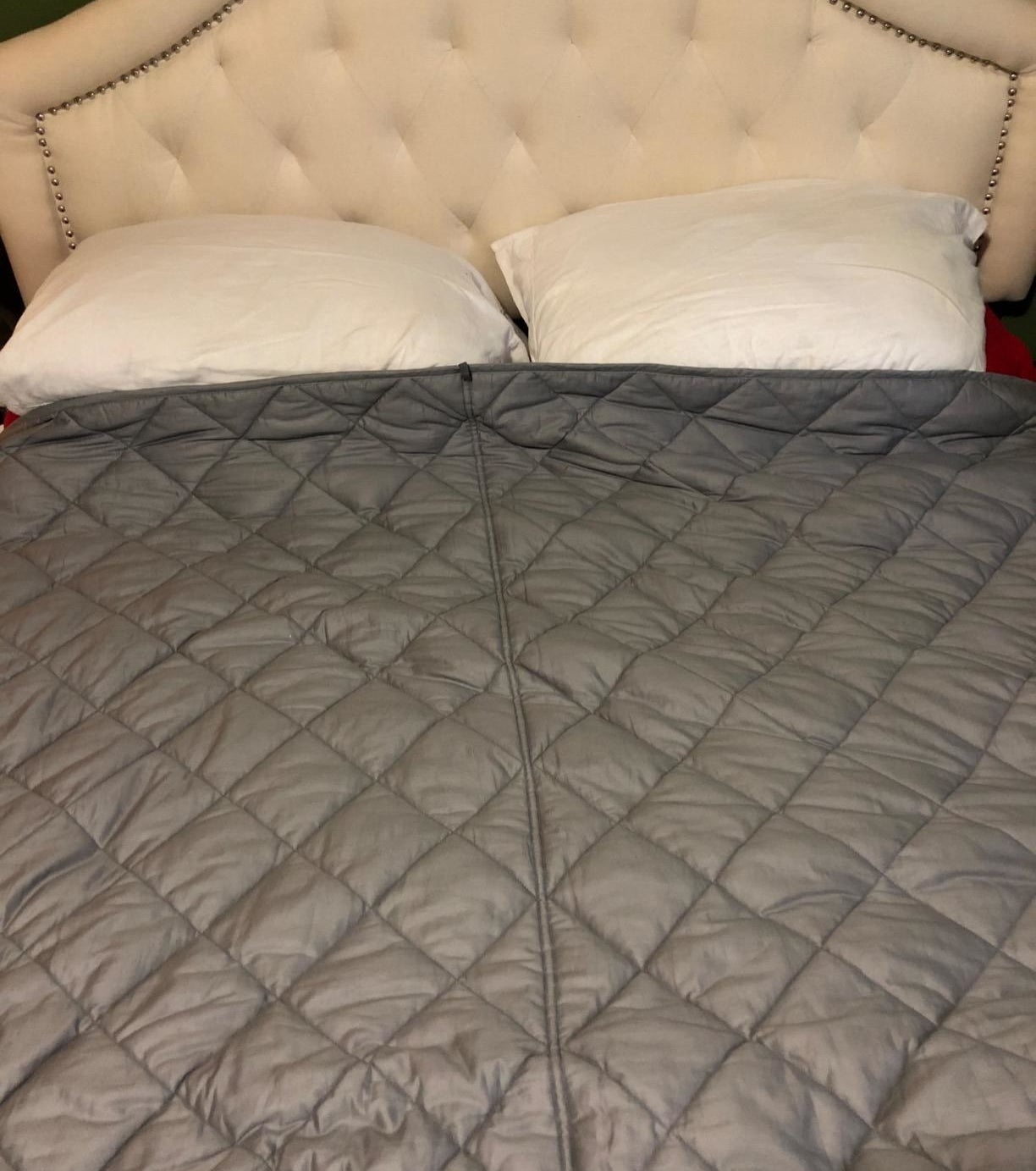 reviewer image of the bedextra weighted blanket on a bed