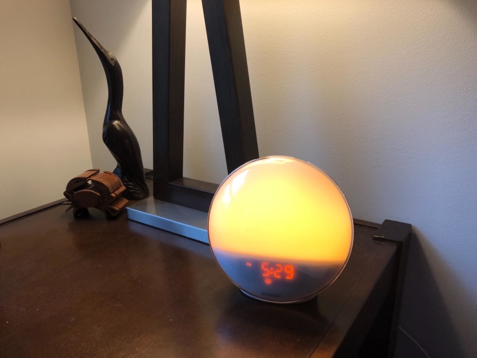 reviewer image of the Wake Up Light Sunrise Alarm Clock on a nightstand