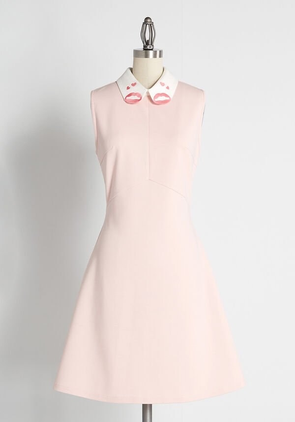 the pink sleeveless shift dress with a white collar