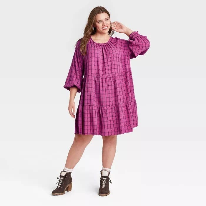 model wears pink plaid baby doll dress 